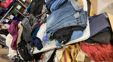 Pile of damaged preloved clothing for textile recycling