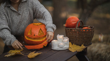 Woman carves Halloween pumpkin